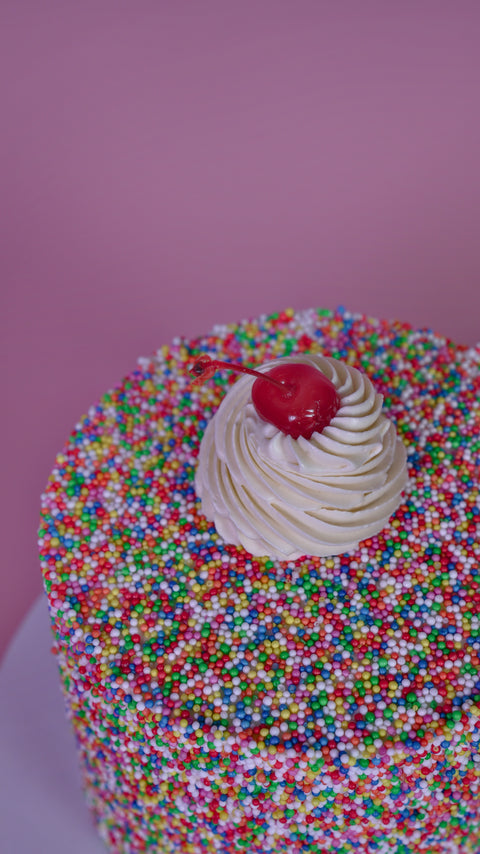 Sprinkle Dream Cake with Cherry.